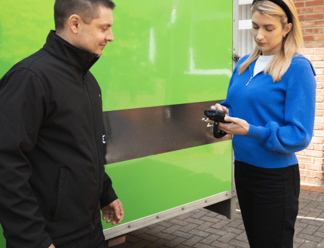 A removals professional carrying out a house survey for a customer